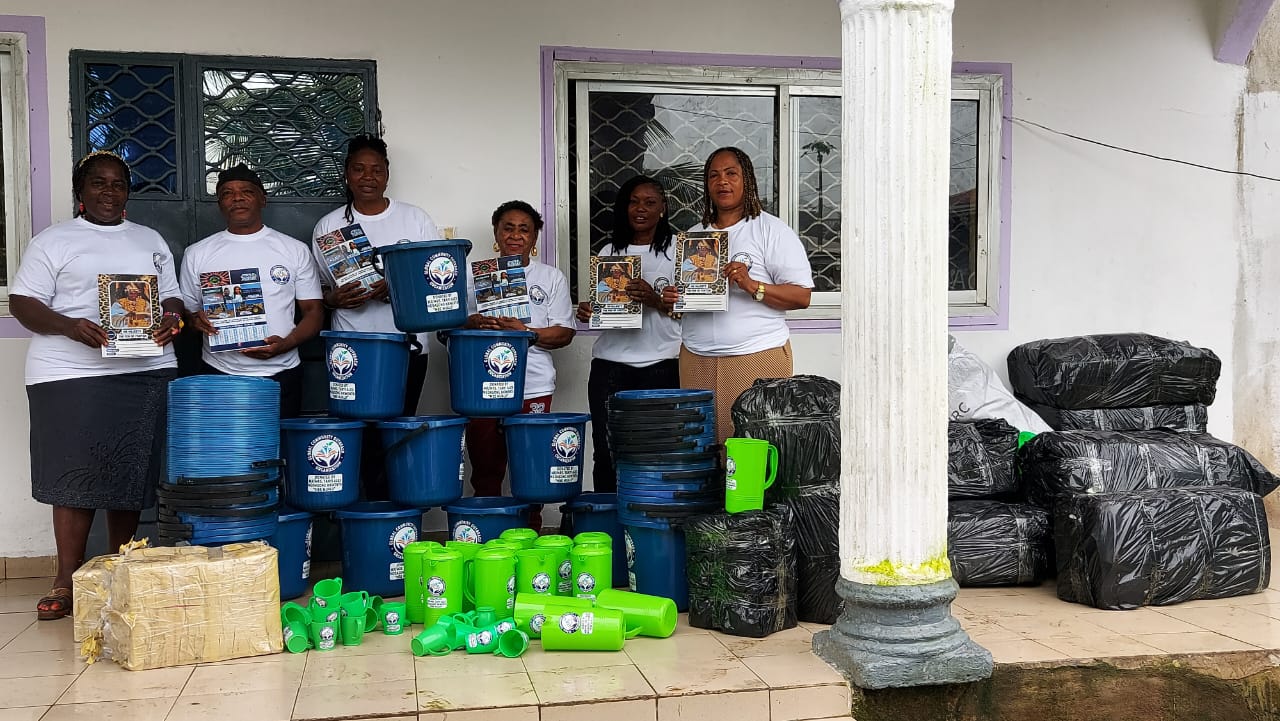 Organization team with stacked buckets, jugs, and relief supplies